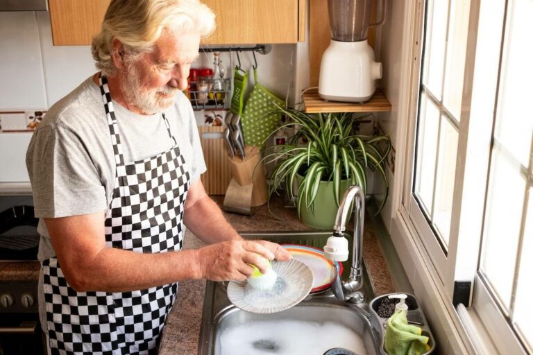 SaraBella Senior Living Man Washing Dishes