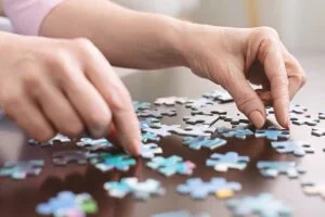 Senior Woman Completing Puzzle_SaraBella Senior Living