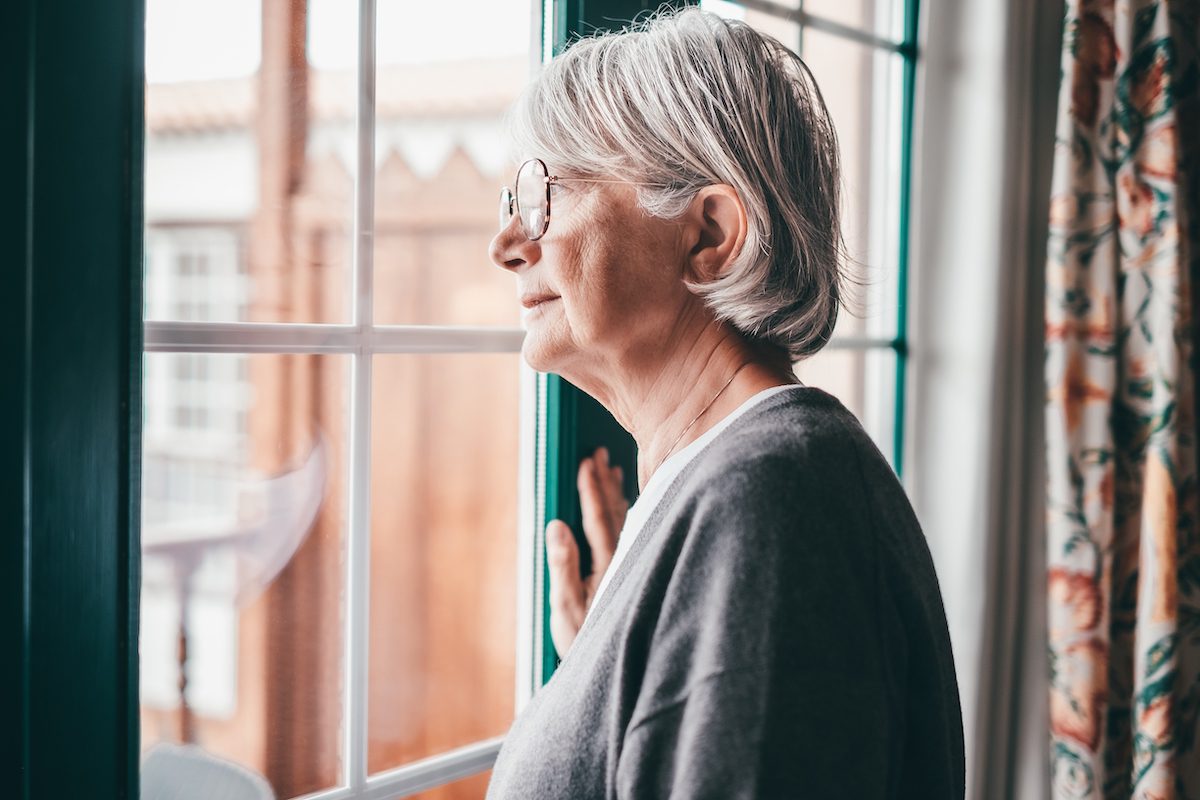 Senior Woman Looking Out Window_Signs of Dementia
