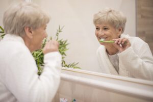 Senior Woman Brushing Teeth_Memory Care in Sarasota