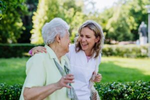 Senior Woman and Caregiver Walking Outside_Benefits of Routine