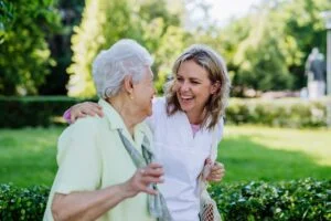 Senior Woman and Caregiver Walking Outside_Benefits of Routine