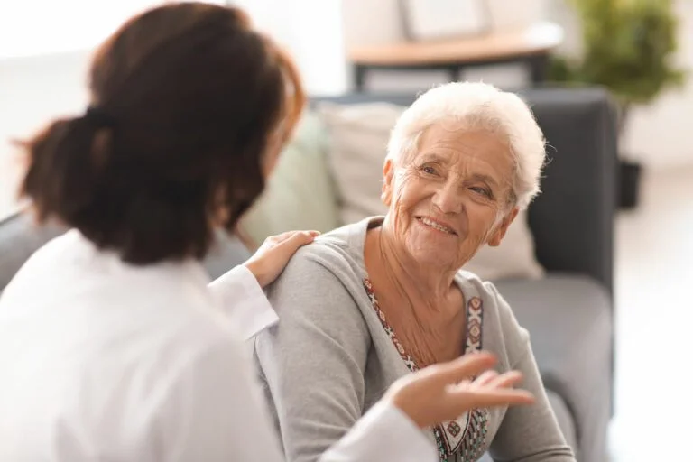 Woman Talking to Older Lady About Senior Living
