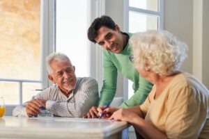 Caregiver talking to two older adults