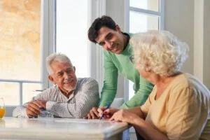 Caregiver talking to two older adults