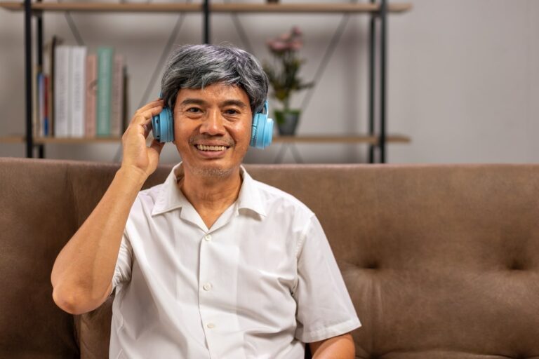 Older adult wearing headphones