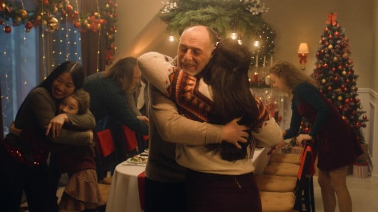 Older man hugging a relative at Christmas