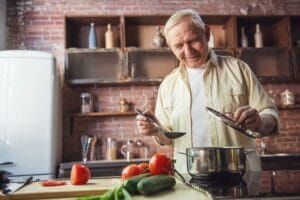 Older man cooking a healthy recipe