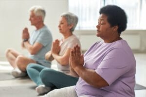 Group of older adults meditating together.