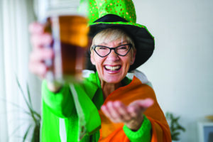 Woman celebrates st. paddys day with a beer