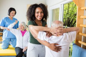 Caregivers helping seniors stretch