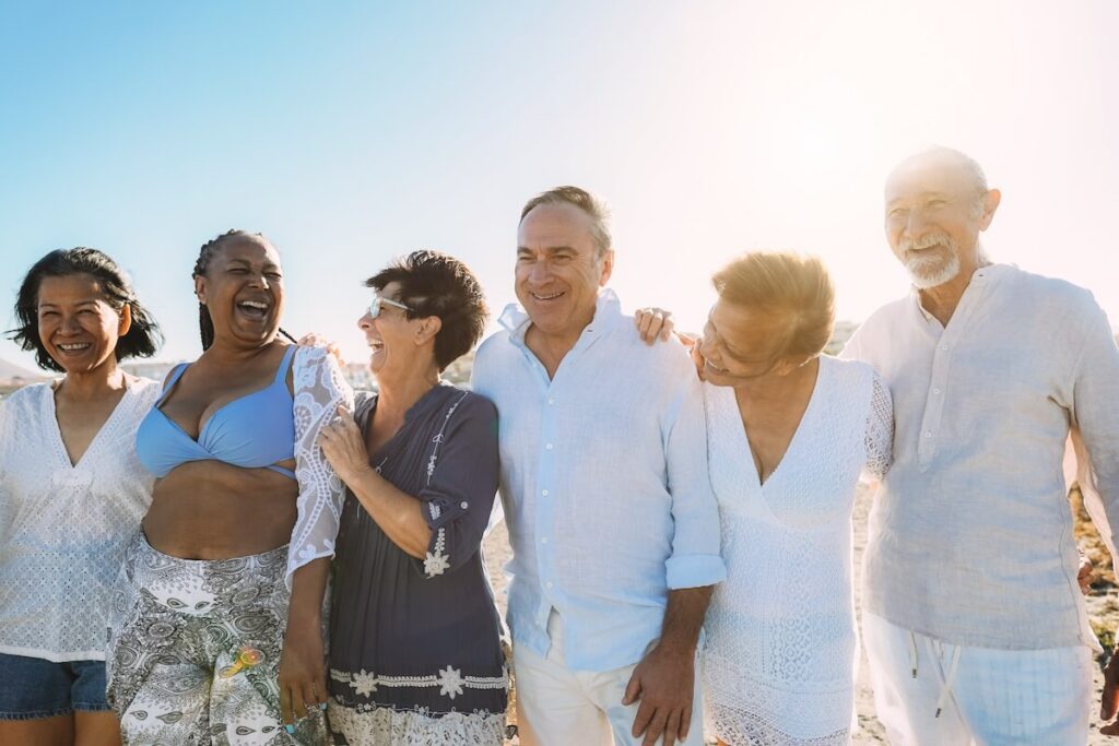 Group of joyful seniors by the beach